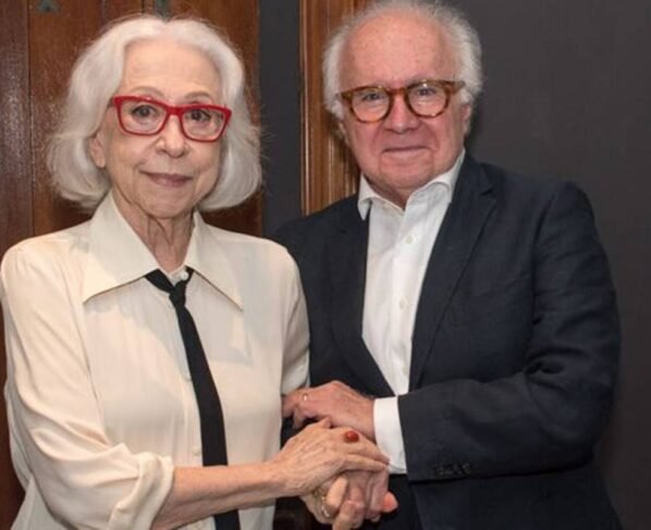 foto colorida de Fernanda Montenegro e Joaquim Falcão de mãos dadas - metrópoles